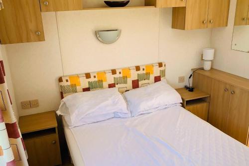 ニュートン・スチュワートにあるStunning 2-Bed Apartment in Newton Stewartの小さなベッドルーム(白いシーツ付きのベッド1台付)