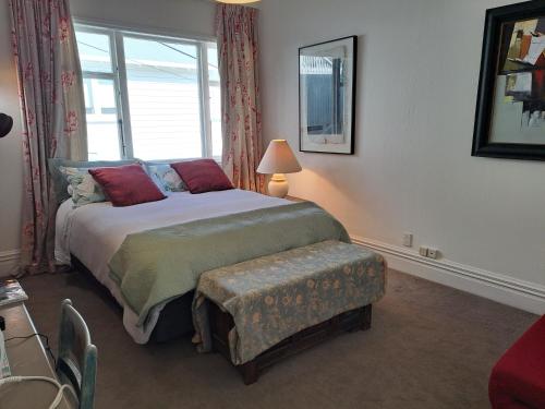 a bedroom with a bed and a window at B and B on Hay Street by the Sea in Wellington