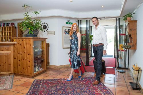 a man and a woman standing in a room at Relax & Vitalhotel Adler in Schruns-Tschagguns