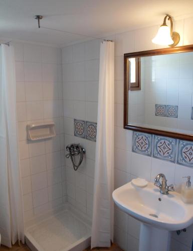 a bathroom with a sink and a shower at Mealos Apartments in Skiros