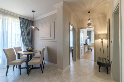 a living room with a dining room table and chairs at Aquamarine - Beach & SPA Hotel- All inclusive in Kranevo