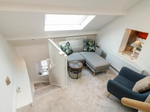 a living room with a couch and a chair at The Hayloft in Matlock