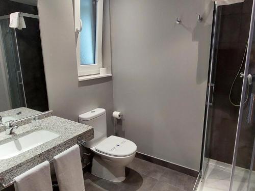 a bathroom with a toilet and a sink and a shower at The Lodge at Ribasol in Arinsal