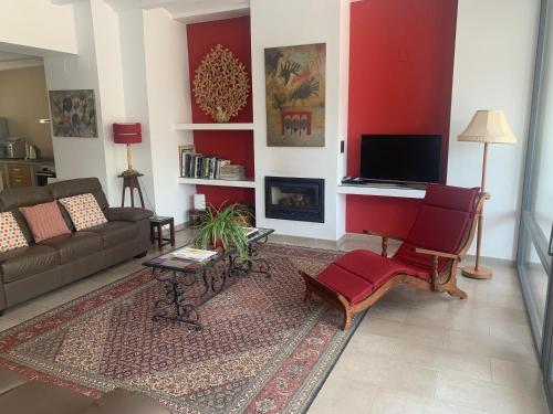 a living room with a couch and a tv at Casa Carmen in Alájar