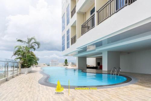 a swimming pool on the side of a building at SLEPTOPIA at Formosa Residence - Apartment 70m2 with Best interior & View in town in Nagoya