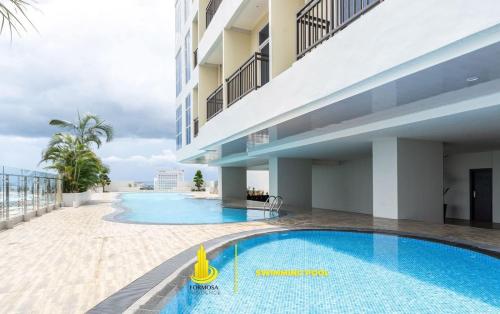 a swimming pool on the balcony of a building at SLEPTOPIA at Formosa Residence - Apartment 70m2 with Best interior & View in town in Nagoya
