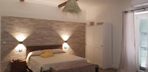 sypialnia z łóżkiem i ceglaną ścianą w obiekcie Casa Rosamari - su Lago di Posta Fibreno, Appartamento con camino w mieście Posta Fibreno