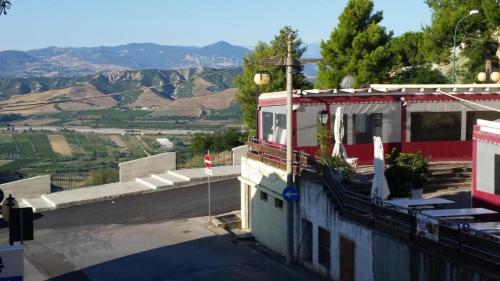 a red train sitting on top of a building at B&B Planet in Montalbano Jonico