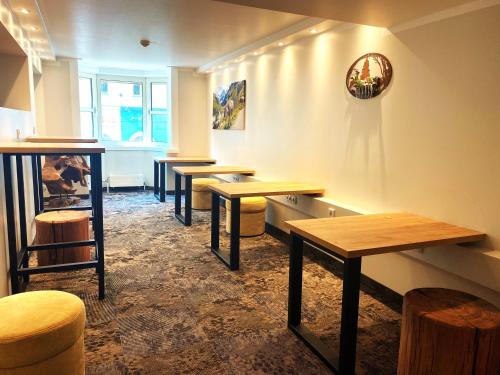 a row of tables and stools in a room at Hotel Enziana Wien in Vienna
