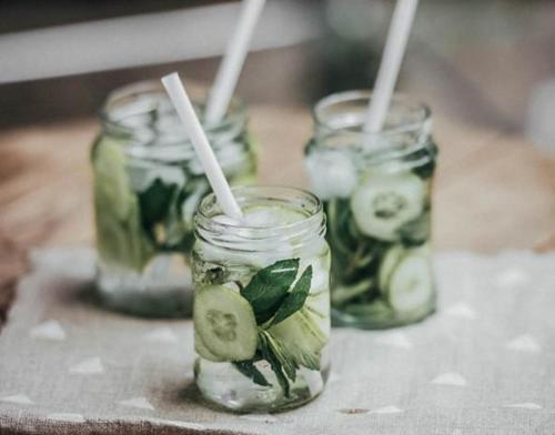three mason jars with pickles on a table at The Bay Hotel & Suites in Vasilikos