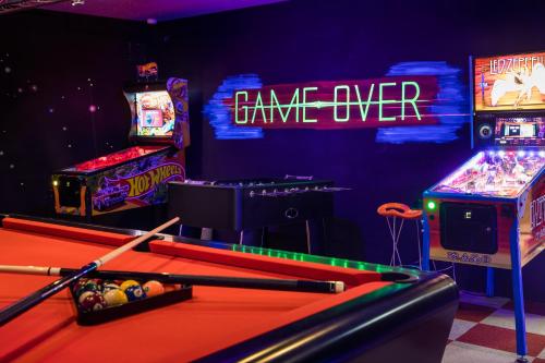 a room with a pool table and arcade games at Raffl's Tyrol Hotel in Sankt Anton am Arlberg