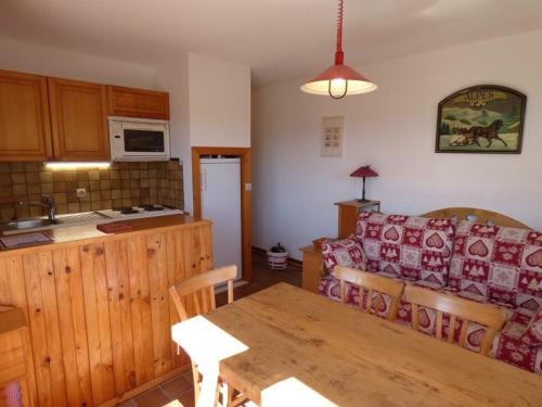 a kitchen and a living room with a couch and a table at Appartement Le Grand-Bornand, 2 pièces, 6 personnes - FR-1-458-108 in Le Grand-Bornand