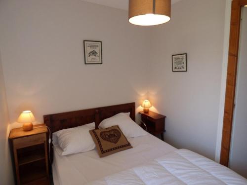 a bedroom with a white bed with two night stands at Appartement Le Grand-Bornand, 2 pièces, 6 personnes - FR-1-458-108 in Le Grand-Bornand