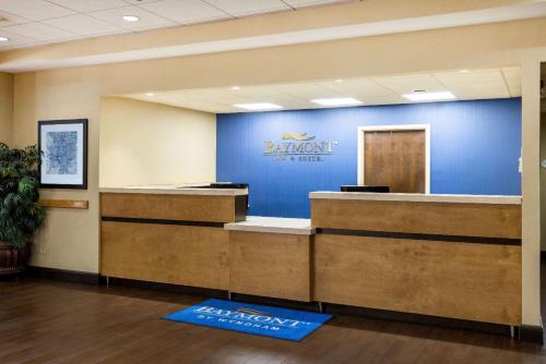 a lobby with a blue wall with a bank sign on it at Baymont by Wyndham Columbus GA in Columbus