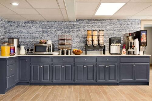 a kitchen with a blue counter top with appliances at AmericInn by Wyndham Branson & Conference Center in Branson