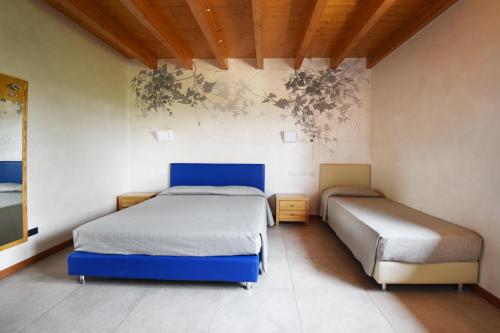 Postel nebo postele na pokoji v ubytování Agriturismo B&B Corte Tonolli