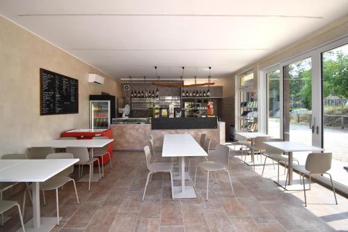 a restaurant with tables and chairs and a counter at Agriturismo B&B Corte Tonolli in Valeggio sul Mincio
