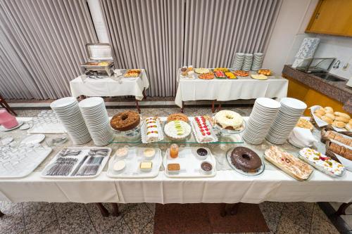 a table with a lot of food on it at Condall Palace Hotel in Nova Prata