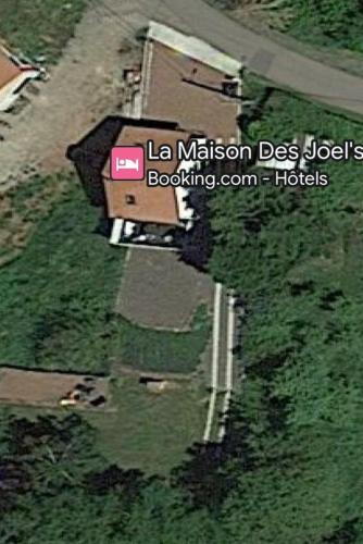 arial view of a building on a road next to a field at La Maison des Joel's in Schorbach