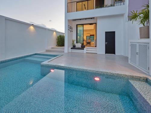 a swimming pool in front of a house at Casa de Yim, Eco Pool Villa in Ao Nang Beach