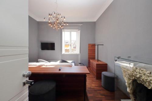 a bedroom with a bed and a desk and a window at Youroom - Coppelle in Rome
