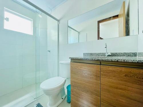 a bathroom with a toilet and a sink and a mirror at Casas em barrerinhas lencois ville in Barreirinhas