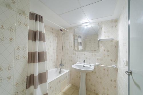 a bathroom with a sink and a mirror and a tub at El Cortijo Escana in Es Cana