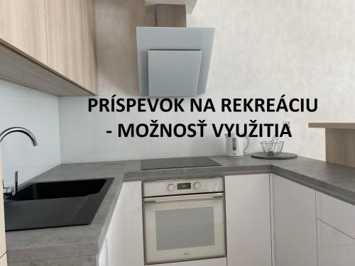 a kitchen with a sink and a counter top at Apartman Hestia in Rajecké Teplice