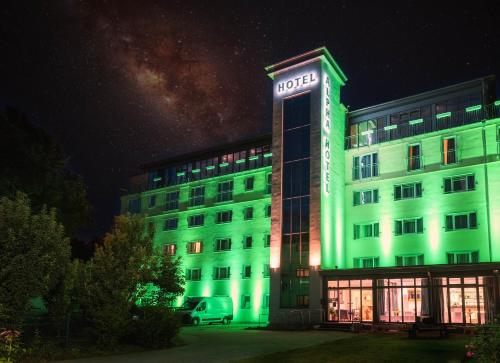 a building with a green light on it at night at ALPHA HOTEL Hermann von Salza in Bad Langensalza