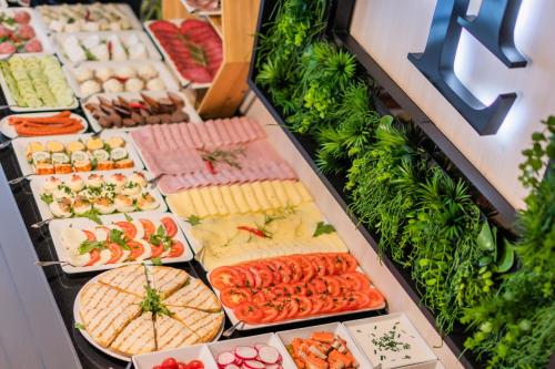 a buffet of different types of food on display at Hotel Lantier Wellness & Spa in Bytom