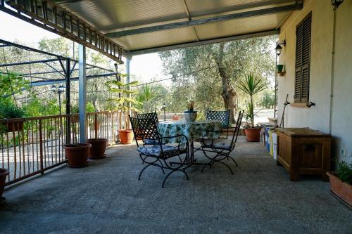 a patio with a table and chairs on a porch at La villa di campagna in Pisticci