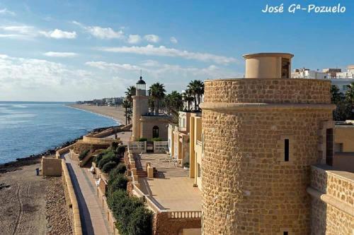 a view of the ocean from a building at Apartamento Merlin in Roquetas de Mar