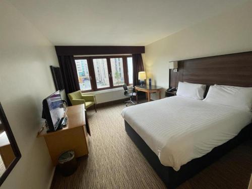 a hotel room with a bed and a television at Copthorne Hotel Manchester Salford Quays in Manchester