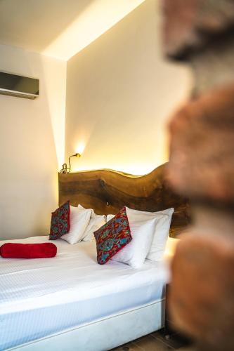 a bedroom with a bed with red pillows on it at West Pera Hotel in Istanbul