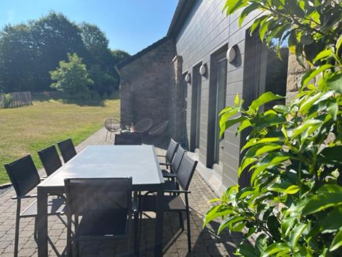 a table and chairs sitting on a patio at Les midis au vert - Les Loges - 11 personnes in Stavelot