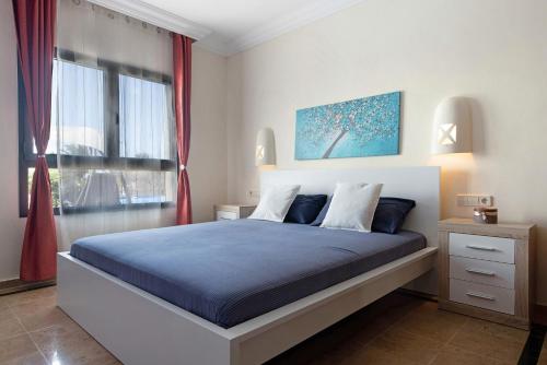 sypialnia z dużym łóżkiem i oknem w obiekcie Villa Montaña Roja w mieście Playa Blanca