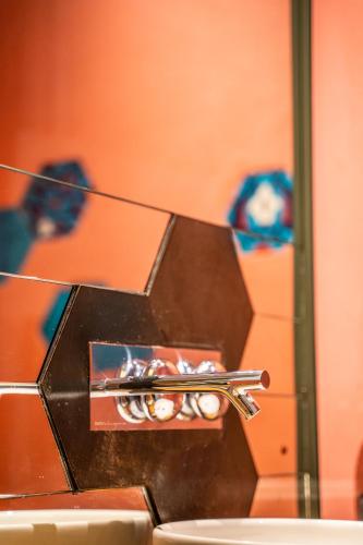 a pair of silver tongs sitting on top of a sink at West Pera Hotel in Istanbul