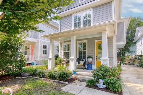 a white house with a yellow door at Holy City Charm - Mins to Dtwn - Beach Shem Creek in Charleston
