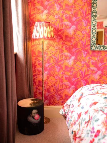 a bedroom with a stuffed monkey in a box next to a bed at The Portobello Hotel in London