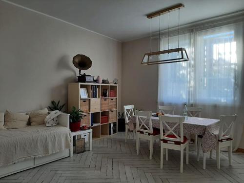 a living room with a table and chairs and a bed at Casa Cybèle in Rovello Porro