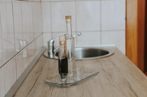two bottles of wine on a counter in a kitchen at I&T apartman in Gospić