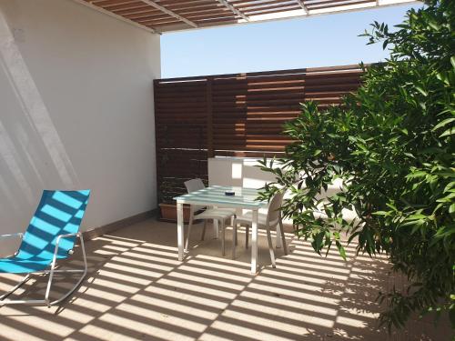 a patio with a table and chairs on a patio at Villa Giadel in Menfi
