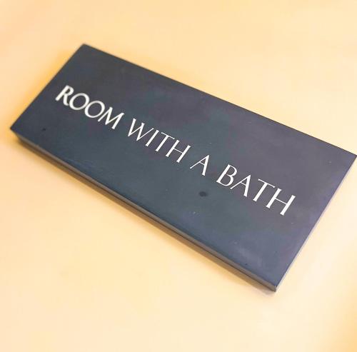 a book with the words room with a bath at The Gower Hotel in Swansea