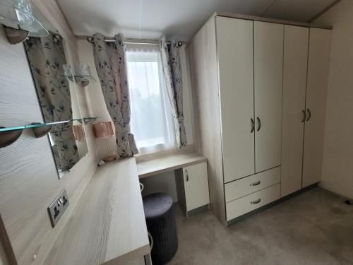 a small room with a desk and a window at Meadow Lodge in South Cerney