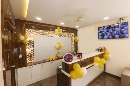 a room with yellow balloons and a mirror at Hotel Sigma Suites in Bangalore