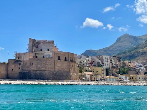 an old castle on the shore of a city at Castello a Mare in Castellammare del Golfo