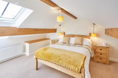 a bedroom with a large bed and a window at Host & Stay - The Hayloft in Ilkley