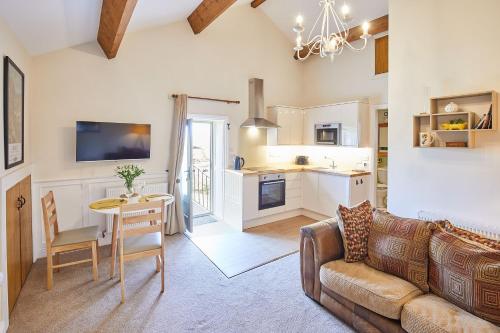 a living room with a couch and a table at Host & Stay - The Hayloft in Ilkley