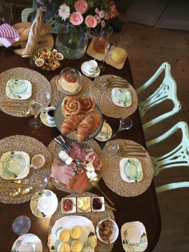 a table with plates of food on top of it at Champagne House - Elegance, Luxury and Charm in Condom