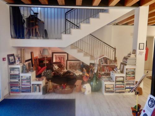 a living room with a staircase and a couch at Ca' Vascon Alloggio Agrituristico in Villa Estense